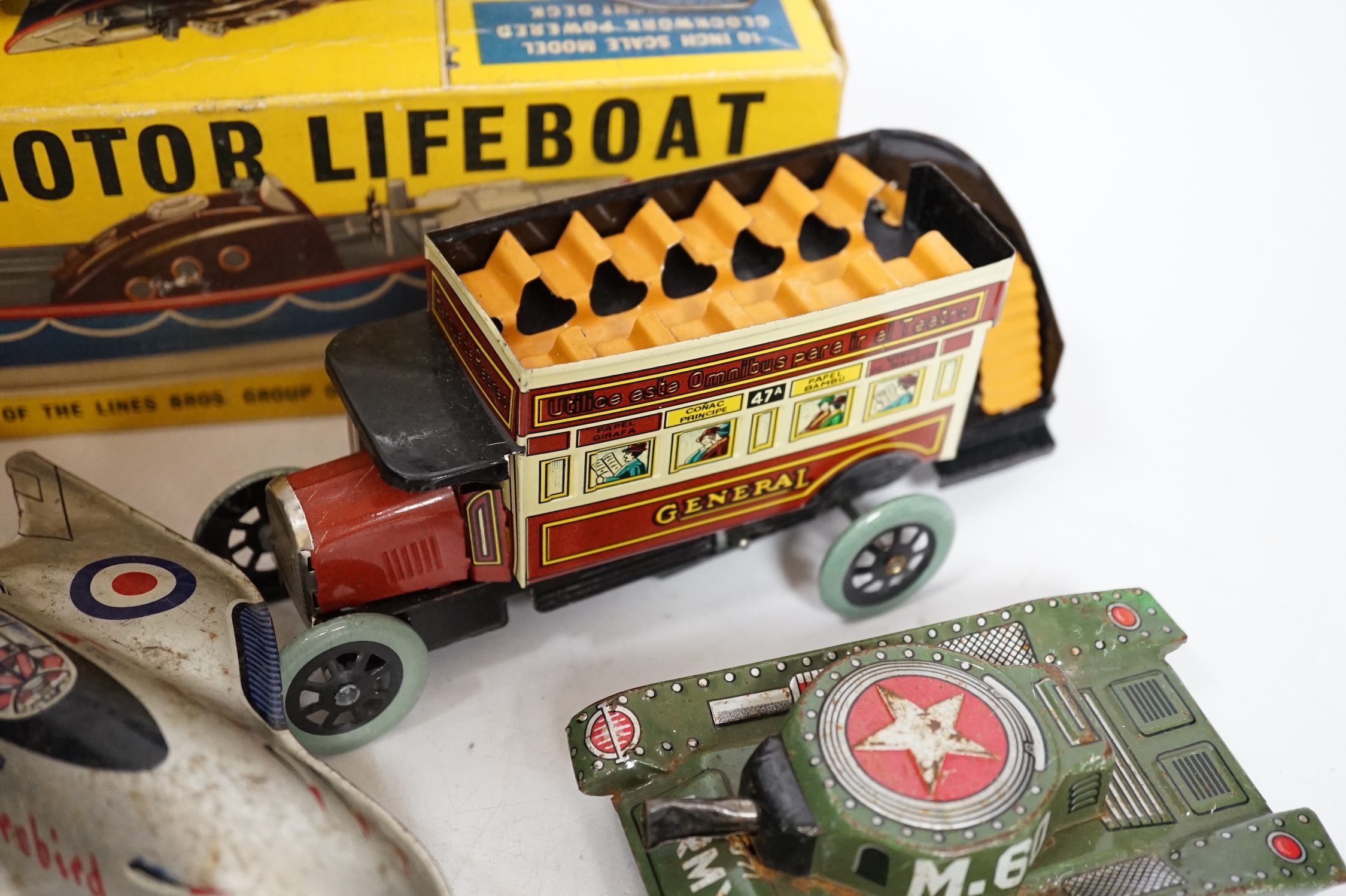 A collection of tinplate toys including cars, a fire engine, a Firebird jet plane, a Tri-ang lifeboat, an Tri-ang Minic tractor, etc. (11), together with a box of boardgames including Vintage Gibson and others; Bandit Ch